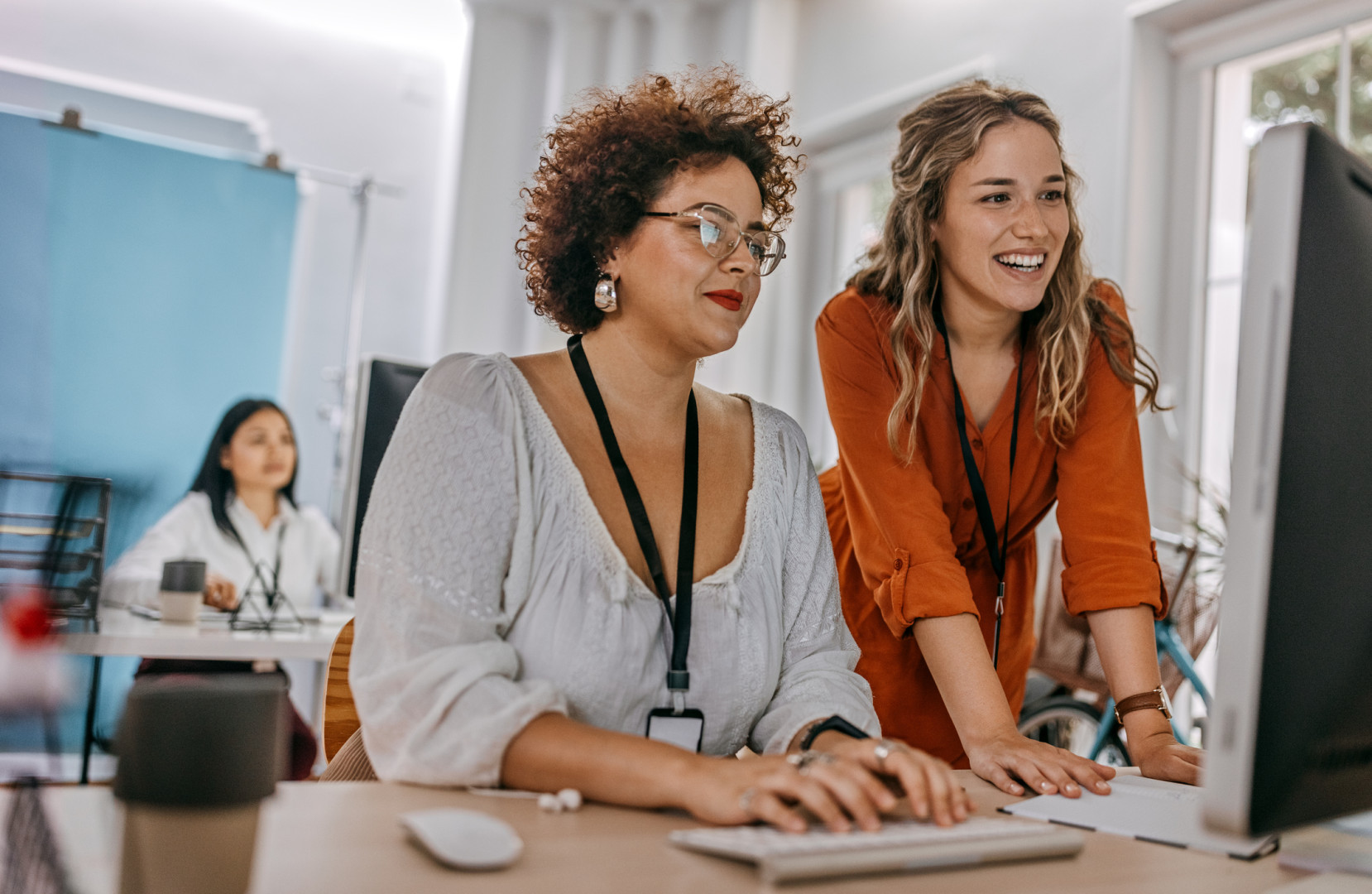 Two business women looking at computer.